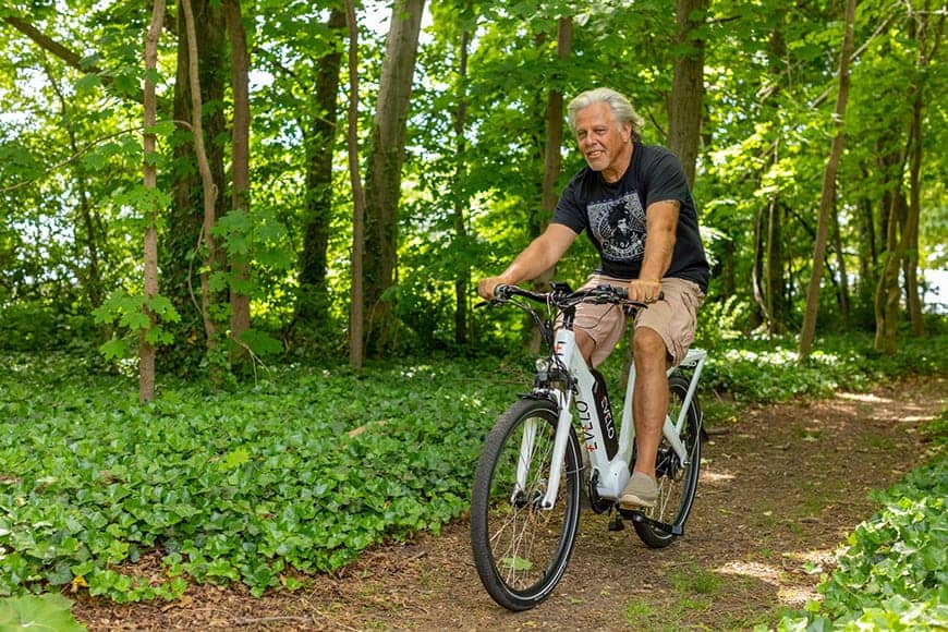 Happy man on e-bike on country trail